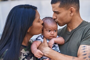 Poster - Hispanic family hugging each other and kissing at street