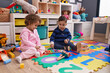 © Krakenimages.com - Adorable boy and girl playing xylophone sitting on floor at kindergarten