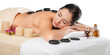 © BillionPhotos.com - Beautiful young woman receiving hot stone massage at salon spa