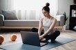 © Arc - Home workout concept woman in the living room with a laptop. Generative AI.
