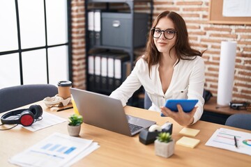 Wall Mural - Young woman business worker using laptop and touchpad at office