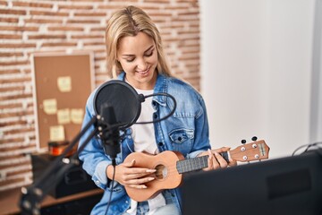 Wall Mural - Young blonde woman musician singing song playing ukelele at music studio