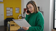© Krakenimages.com - Mature hispanic woman with grey hair business worker speaking on the phone reading document at office
