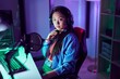 © Krakenimages.com - Young chinese woman streamer playing video game using computer at gaming room