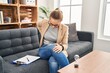 © Krakenimages.com - Young woman working at consultation office suffering of backache, touching back with hand, muscular pain