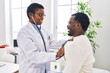 © Krakenimages.com - Man and woman doctor and patient having medical consultation auscultating chest at clinic
