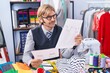 © Krakenimages.com - Young blond man tailor looking clothing design draw at clothing factory