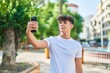 © Krakenimages.com - Young hispanic teenager smiling confident making selfie by the smartphone at park
