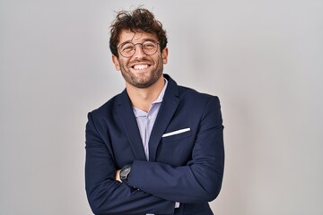 Poster - Hispanic business man wearing glasses happy face smiling with crossed arms looking at the camera. positive person.