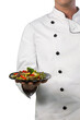 Chef in white uniform holding  plate with food  gagainst white background