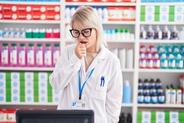 Poster - Young caucasian woman working at pharmacy drugstore feeling unwell and coughing as symptom for cold or bronchitis. health care concept.