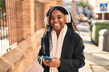 Poster - African american woman smiling confident listening to music at street