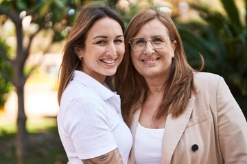 Poster - Mother and daughter smiling confident hugging each other at park