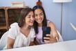 © Krakenimages.com - Two women mother and daughter make selfie by smartphone at home
