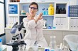 © Krakenimages.com - Hispanic girl with down syndrome working at scientist laboratory rejection expression crossing arms and palms doing negative sign, angry face