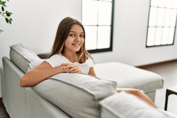 Canvas Print - Adorable girl smiling confident sitting on sofa at home