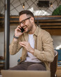 © Miljan Živković - Man adult caucasian male use mobile phone smartphone talk happy smile