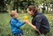 © kieferpix - Portrait of little boy giving his mother flowers showing love and affection. Parent child relationship, Mother's Day concept.