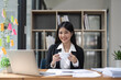 © Natee Meepian - Happy young business Asian girl working at a office with coffee and laptop