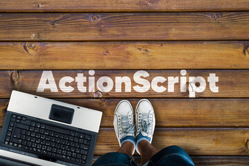 Wall Mural - legs in sneakers standing next to laptop and wordactionscript on wooden floor. actionscript programm