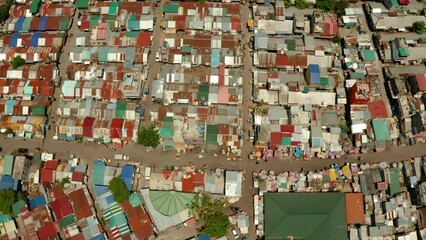 Poster - Poor area in the slums of Manila with density houses and streets from above.