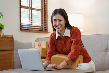 Small businesses SME owners female entrepreneurs check online orders to prepare to pack the boxes, sell to customers, sme business ideas online