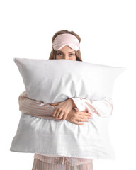 Wall Mural - Young woman with sleeping mask and pillow on white background