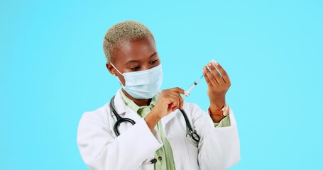 Canvas Print - Covid, vaccine and a doctor black woman on a blue background in studio for healthcare or treatment. Medical, insurance and mask with a female medicine professional holding a syringe for injection