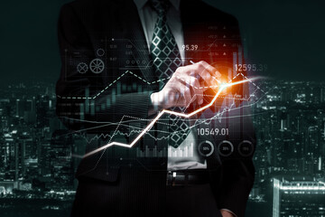 Businessman analyst working with digital finance business data graph showing technology of investment strategy for perceptive financial business decision. Digital economic analysis technology concept.