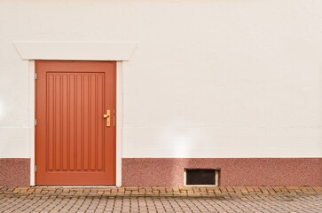 Wall Mural - View of city building with red wooden door