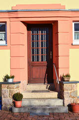 Wall Mural - View of beautiful building with wooden door and steps