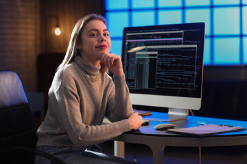 Female programmer working in office at night