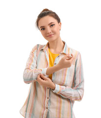 Wall Mural - Young woman rolling up her sleeve on white background