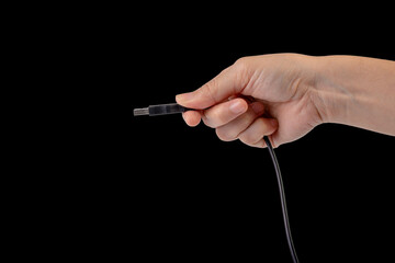 Poster - Hand and usb cable isolated on black background 