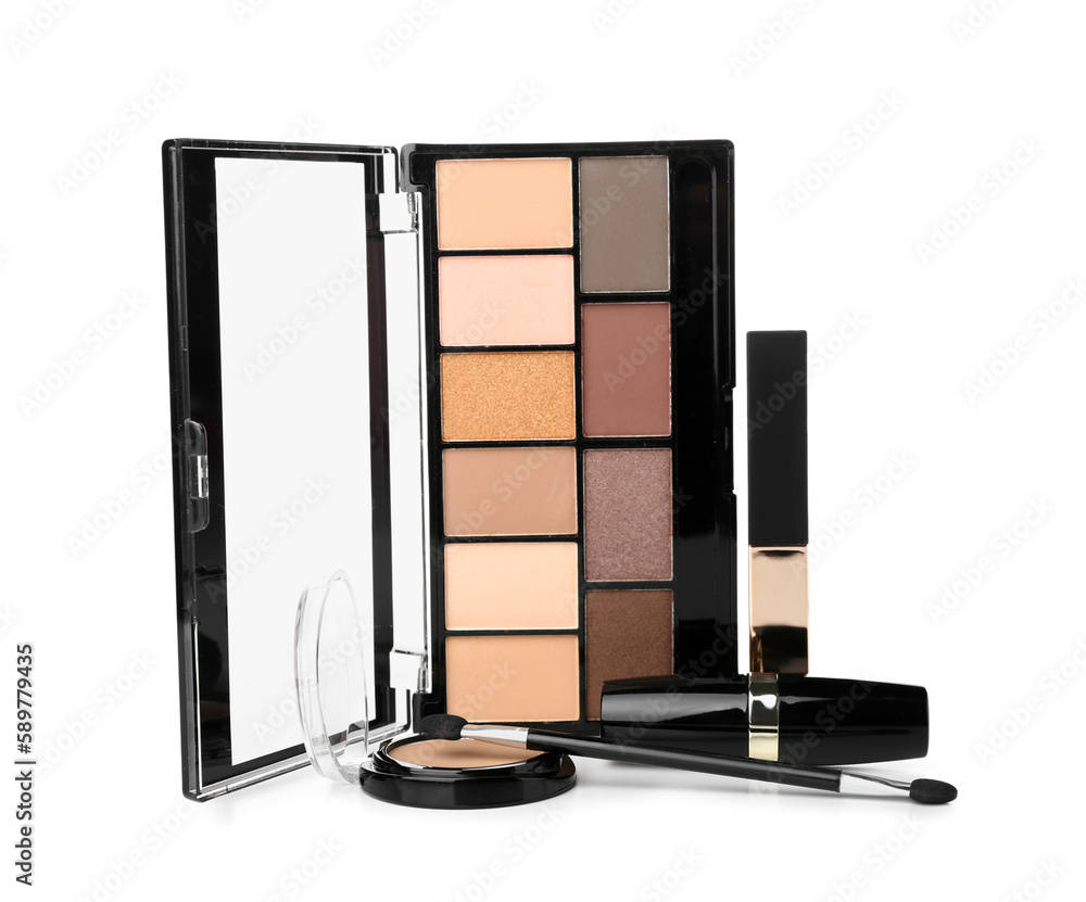 Decorative cosmetics with brush on white background