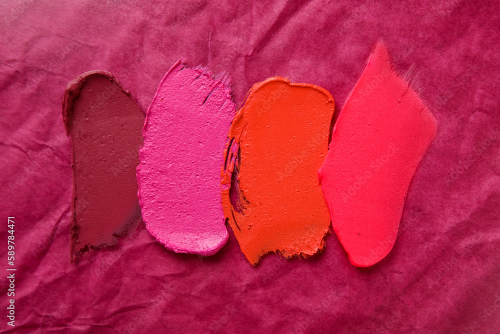 Different lipstick strokes on color background