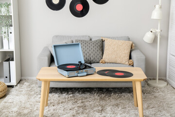 Canvas Print - Record player with vinyl disks on table in interior of living room