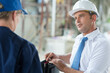 © auremar - portrait of an engineer talking to colleague