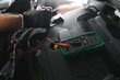 © Serhii - Car mechanic is using a multimeter with voltage range measurement to check the voltage level of the car battery.