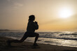 © sutulastock - beautiful young girl is engaged in fitness on the seashore at dawn