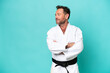 © luismolinero - Middle age caucasian man isolated on blue background doing karate keeping the arms crossed