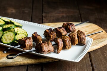 Poster - Closeup of a Steak Shish Kababb with a barbecued zucchini side dish