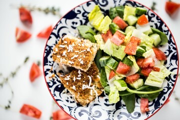 Closeup shot of a healthy breakfast with meat and a fresh vegetable salad put on the table