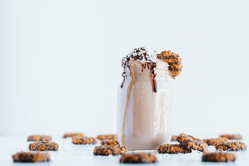 Sticker - Closeup shot of a delicious cookie shake in a glass jar surrounded by cookies