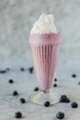 Sticker - Vertical closeup shot of a glass of triple berry shake with cream on the top