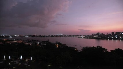 Canvas Print - Mesmerizing view of the sunset sky over the night city in Ivory Coast, Abidjan