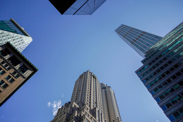 Wall Mural - new york manhattan skyscrapers view from the street to the top of the building on sunny clear day