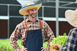 © Prathankarnpap - Smiling agriculture business owner talking with costumer in hydroponics greenhouse plantation