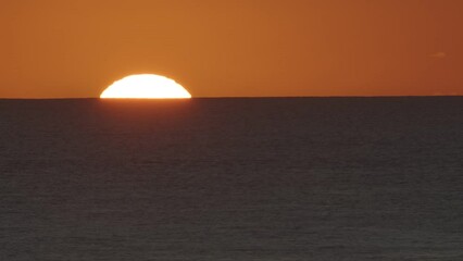 Wall Mural - beautiful evening sunset with big sun in the atlantic ocean at portugal coast.