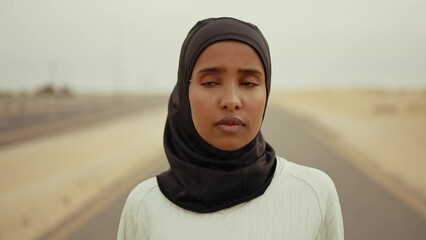 Wall Mural - Beautiful female runner wearing sport abaya running in the desert in dubai, united arab emirates. Concept about sport, and muslim culture